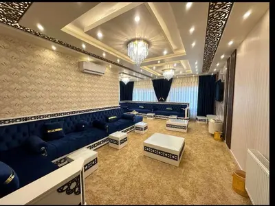 a large living room with blue couches and tables at شقق فاخرة حي الشميساني الأردن in Amman