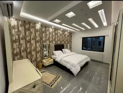 a bedroom with a bed and a tv in it at شقق فاخرة حي الشميساني الأردن in Amman