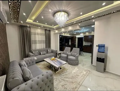 a living room with a couch and a table and chairs at شقق فاخرة حي الشميساني الأردن in Amman