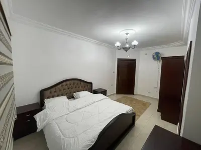 a bedroom with a large bed in a room at شقة مفروشة in Rujm Maghghijhah