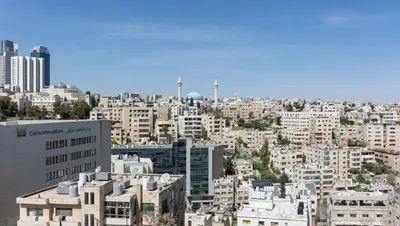 an aerial view of a city with tall buildings at Prestige hotel apartment in Amman
