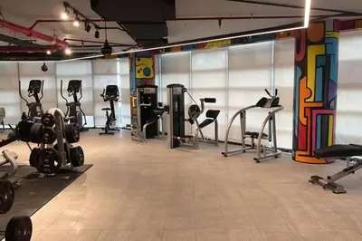 a gym with many exercise equipment in a room at Boulevard, Abdali Luxury 1 BR Apartment in Amman