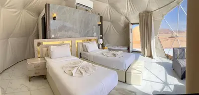 a room with two beds in a tent at Rum Star Desert Camp in Wadi Rum