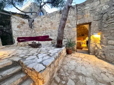 a stone wall with a tree in it at family home Lodge in Dana