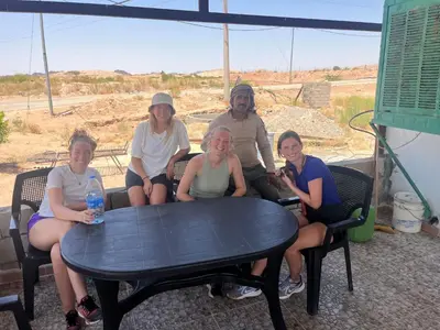 a group of people sitting around a table at family home Lodge in Dana