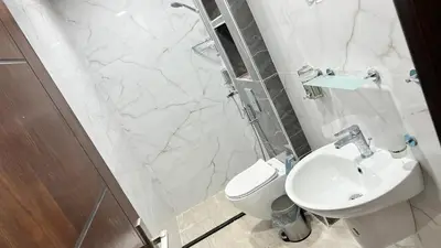 a bathroom with a toilet and a sink and a shower at شقة بغرفه نوم واحدة عمو سامي in Amman
