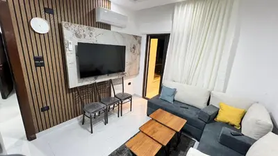 a living room with a couch and a tv at شقق عمو سامي بغرفتين نوم 2 in Amman