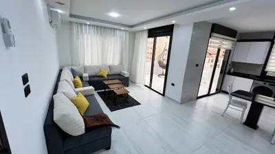 a living room with a couch and a table at شقة رووف اطلاله رائعه عمو سامي 20 in Amman