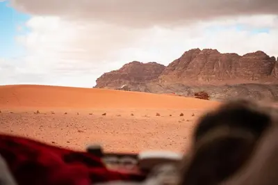 a view of a desert with mountains in the background at Moon shine camp in Wadi Rum