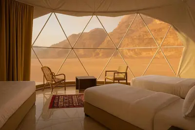 a room with two beds and a large window at Desert Elegance Luxury Bedouin Camp Panoramic View in Wadi Rum
