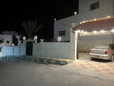 a car parked in front of a building at night at Bait al salam in Um Qeis