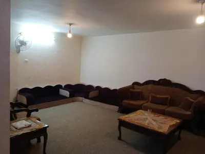a living room with two couches and two tables at Bait al salam in Um Qeis