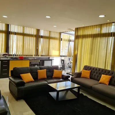 a living room with a couch and a coffee table at unique one bedroom roof in Amman