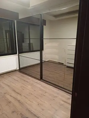 a room with glass walls and a wooden floor at Apartment in Khalda in Amman