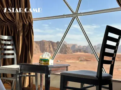 a table and chairs with a view of the desert at 7star camp in Wadi Rum