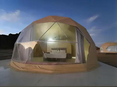 a tent with a bed inside of it at Rum Honeymoon Camp in Wadi Rum