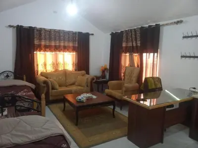 a living room with a couch and a table at Jerash Roman Gate studio chalet ستوديو شاليه بوابة جرش الرومانيه الشماليه in Jerash