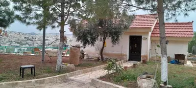 a small house with a view of a city at Jerash Roman Gate studio chalet ستوديو شاليه بوابة جرش الرومانيه الشماليه in Jerash