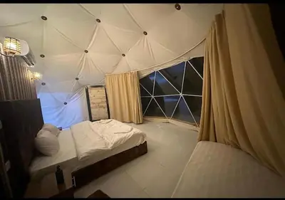 a room with a tent with a bed and a window at Wadi rum stay & tours in Wadi Rum