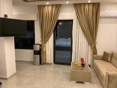 a living room with a couch and a large window at استديو فندقي راقي in Amman