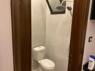 a small bathroom with a toilet and a shower at استديو فندقي راقي in Amman
