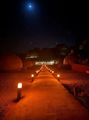 a row of lights on a beach at night at Desert Oasis Lodge in Wadi Rum in Disah