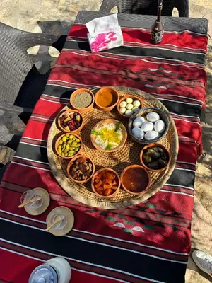a table with a plate of food on a table at منتزه واكواخ كركوش in Ajloun