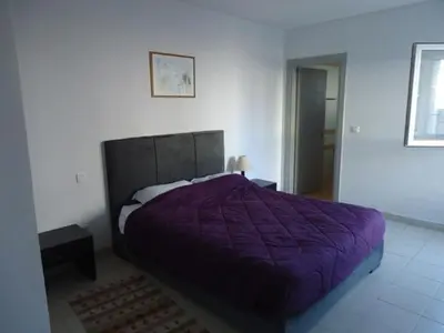a bedroom with a purple bed in a room at Samira House in Amman
