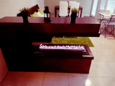 a piano in a living room with a table and chairs at Two Bedroom Shmeisani Apartment in Amman
