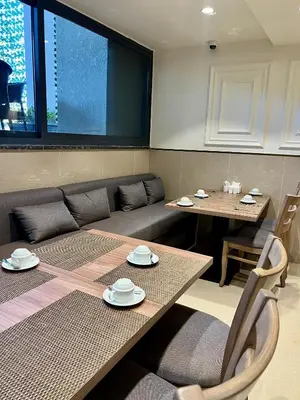 a living room with a couch and a table and chairs at Saraya Abdeen Hotel in Aqaba
