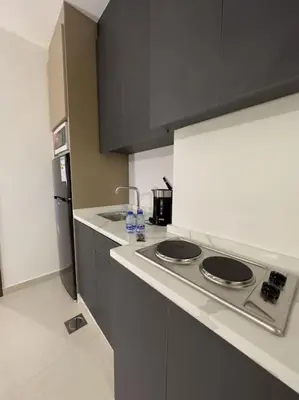 a kitchen with a stove and a counter top at Stylish Luxe Apartment F/R 0001 in Amman
