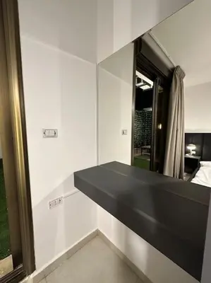 a black bench in a room with a mirror at Stylish Luxe Apartment F/R 0002 in Amman