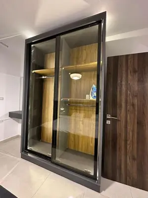 a glass door in a room with a shelf at Stylish Luxe Apartment F/R 0002 in Amman