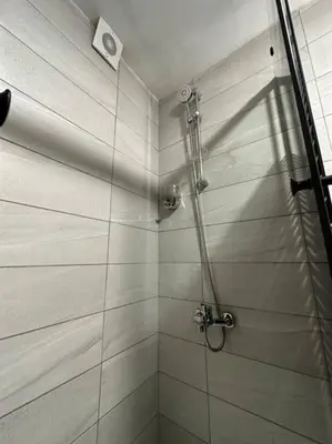 a shower with a glass door in a bathroom at Stylish Luxe Apartment F/R 0004 in Amman
