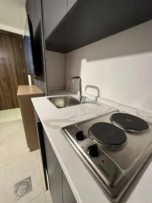 a kitchen with a stove and a sink at Stylish Luxe Apartment F/R 0005 in Amman