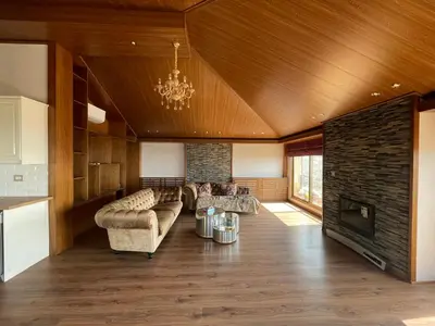 a living room with a couch and a fireplace at Horizon Loft in Bilāl