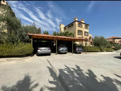 two cars parked in a garage with a building in the background at Horizon Loft in Bilāl