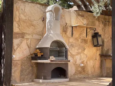 an outdoor pizza oven in a stone wall at Horizon1 in Amman