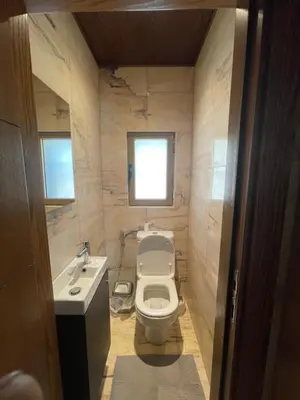 a small bathroom with a toilet and a sink at Horizon1 in Amman
