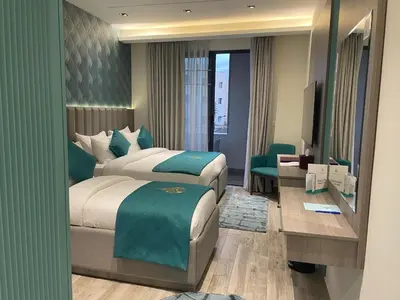 a hotel room with a bed and a desk at Soho Midtown in Ash Shumaysānī