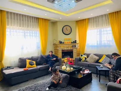 a group of people sitting in a living room at Laura's Stylish Villa in Madaba