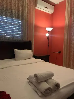 a bedroom with a bed with towels on it at Laura's Stylish Villa in Madaba