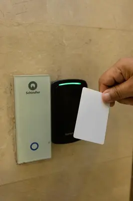 a hand holding a piece of paper next to a nintendo wii at Luxurious in Abdoun Tower at 11th Floor in Amman