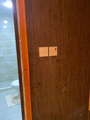 a wooden door in a bathroom with a toilet at Camp safaa rum in Wadi Rum