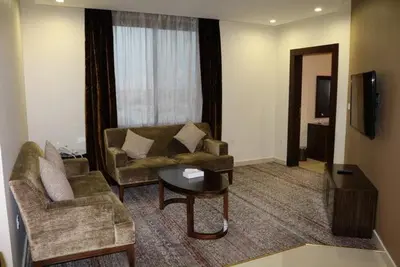 a living room with a couch and a table at look house in Amman