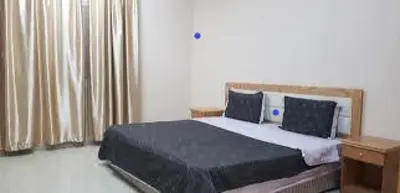 a bedroom with a large bed and a window at look house in Amman