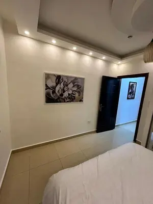 a bedroom with a bed and a painting on the wall at Luxury Hotel apartment in Amman