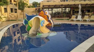 a swimming pool with a statue in the middle of it at Samarah Resort D32 in Sowayma