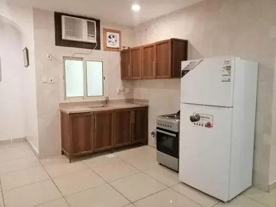 a kitchen with a white refrigerator and a sink at 2332 Guest House in Irbid