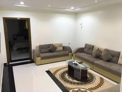a living room with couches and a table and a mirror at 2332 Guest House in Irbid
